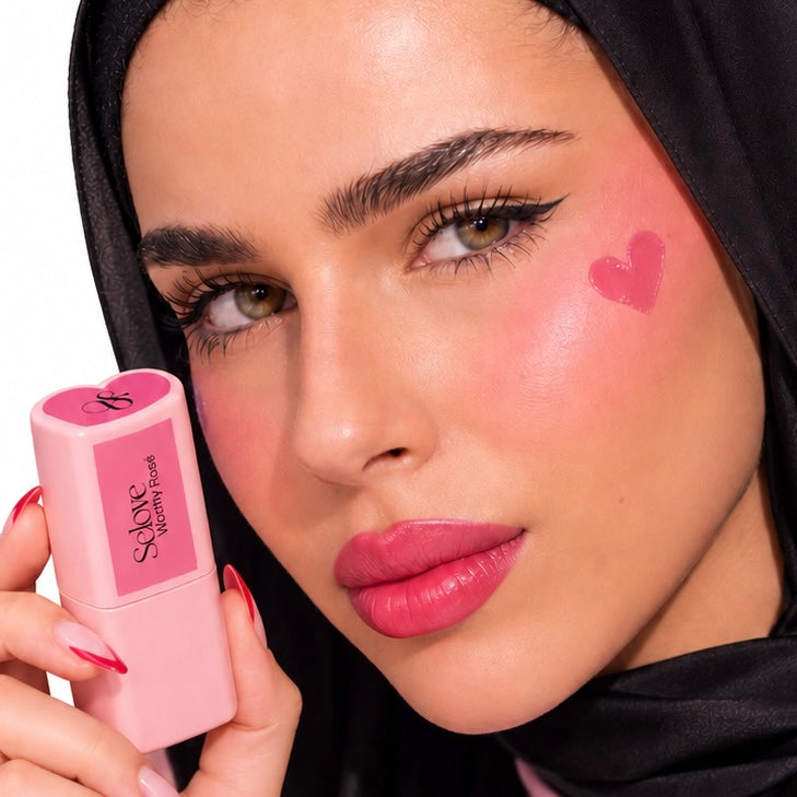 Selove model holding a pink blush stick